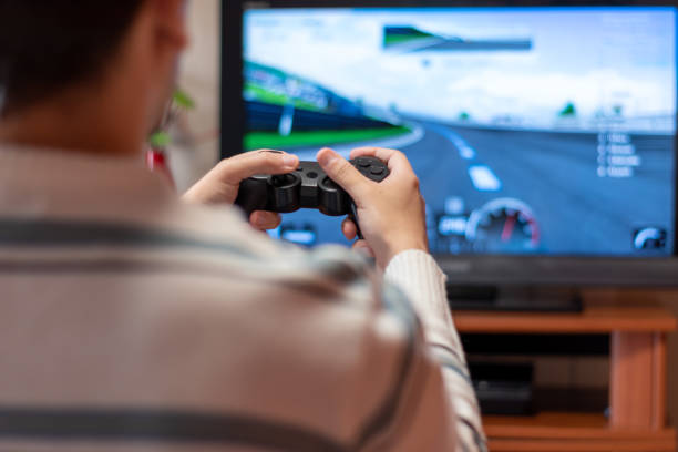 istock Man playing with game console at home. Concept of playing with the console 1309060078