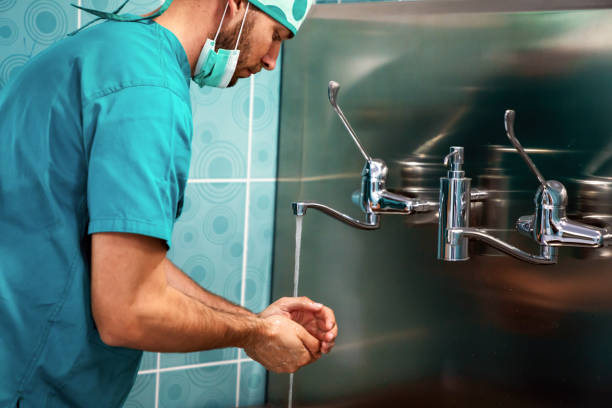 istock Doctor surgeon preparing for surgery and washes his hands 1309062875