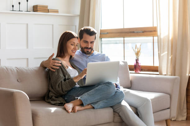 istock Young Caucasian couple rest at home using laptop 1309063564