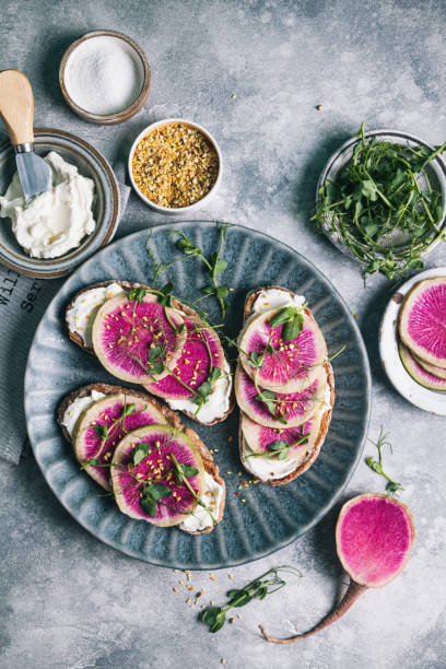 istock Watermelon radish toast with cream cheese and micro-green peas. 1309064794