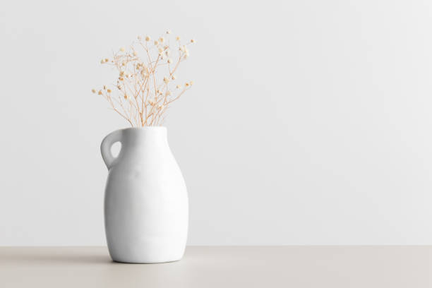 istock Dried gypsophila in a vase on a beige table. Flat lay with blank copy space. 1309064916