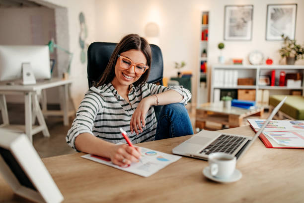 istock Beautiful woman sitting and working in the office 1309064984