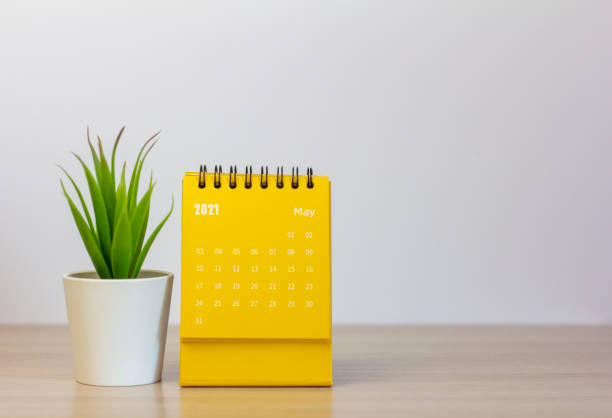 istock Flip the calendar for May 2021. Desktop calendar for planning, scheduling, assigning, organizing, and managing each date. 1309065911