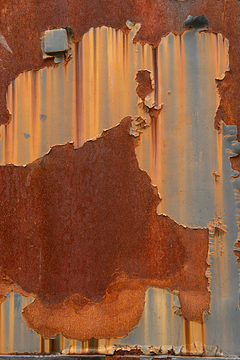 Rusted green iron surface of a old train in a beautiful rough, industrial pattern