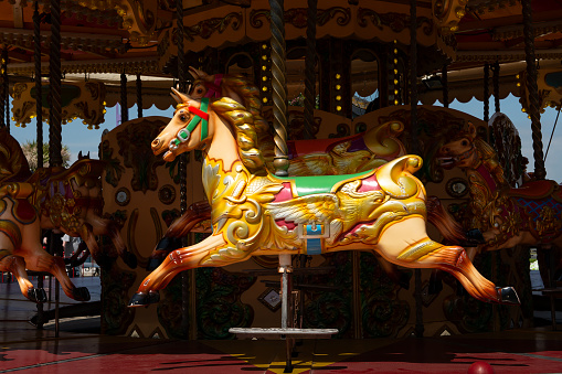 Beautiful empty colorful horse on a merry go round attraction