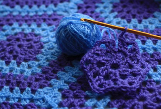 Plaid crocheted from blue and lilac threads Plaid, Crochet, Knitting, Needlework, Hobby, Blanket, Bedspread, Knit, Weave, Handmade, thread, Blue, Lilac, Rows, Openwork, Crochet, Columns, Hexagon, Fragment lacemaking photos stock pictures, royalty-free photos & images