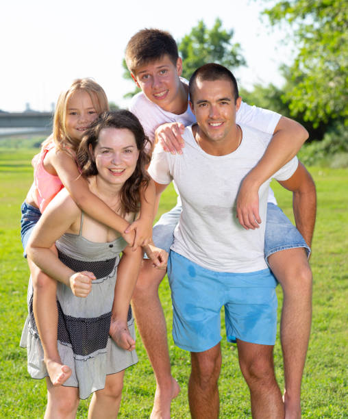 istock Parents piggybacking children 1309069855