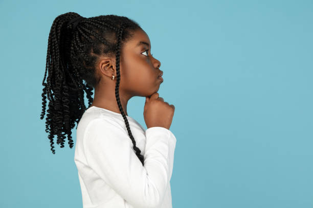 istock Handsome african little girl portrait isolated on blue studio background with copyspace 1309070775