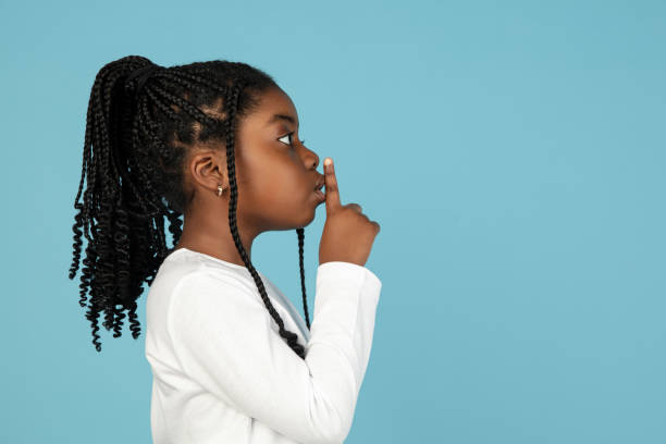 istock Handsome african little girl portrait isolated on blue studio background with copyspace 1309070778