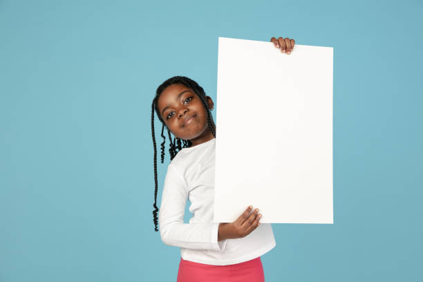 istock Handsome african little girl portrait isolated on blue studio background with copyspace 1309070780