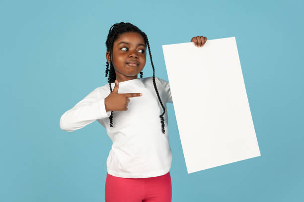 istock Handsome african little girl portrait isolated on blue studio background with copyspace 1309070794