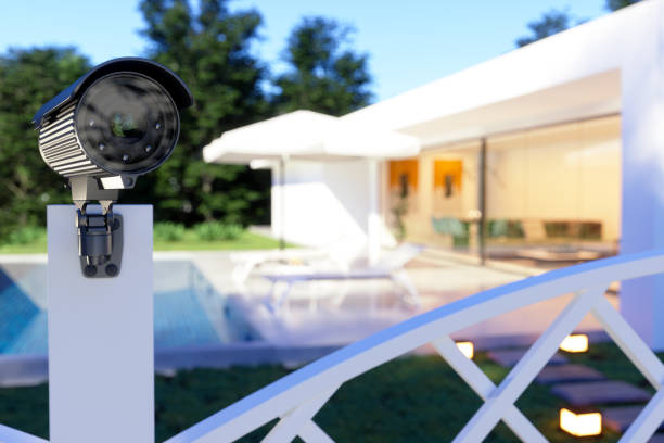 exterior of a villa with security camera at the entrance of the garden. - blurred motion audio imagens e fotografias de stock