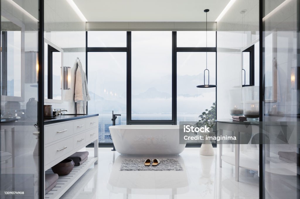 Luxury Bathroom Interior With hot tub And Beautiful Sea View Interior of a contemporary luxury white bathroom with washstand and bathtub. Bathroom Stock Photo