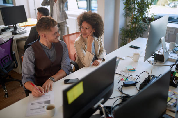 istock colleagues talking, smiling, watching each other at work  in modern open space office. casual modern business 1309074930