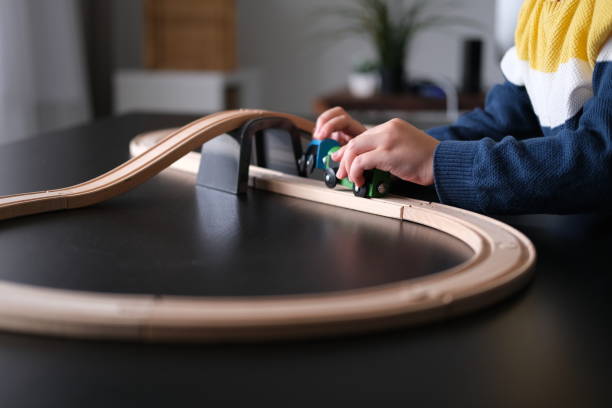 Cute little boy playing with wooden train