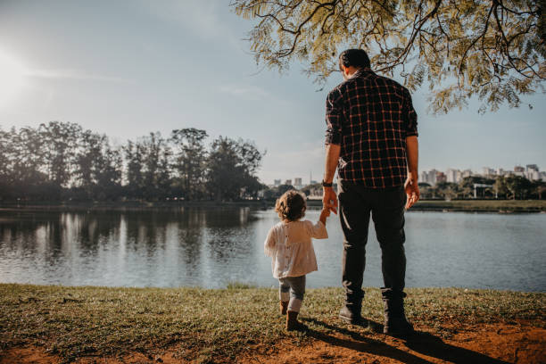 istock Father and daughter at lakeside 1309076665