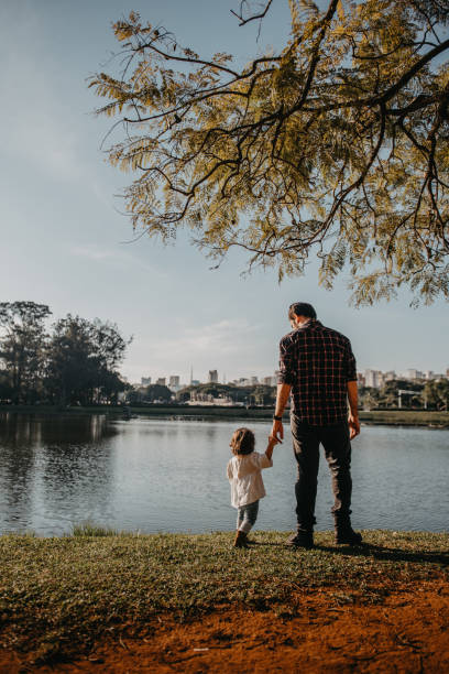istock Father and daughter at lakeside 1309076675