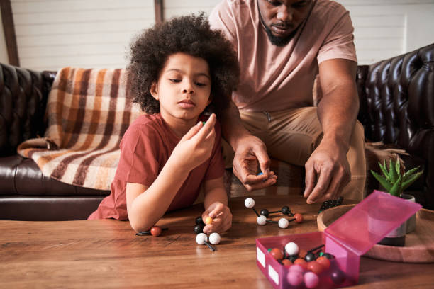 istock Father sitting at the sofa with his son and enjoying a pleasant conversation 1309078253