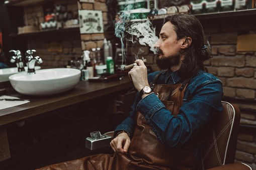 Razor sitting and smoking cigar