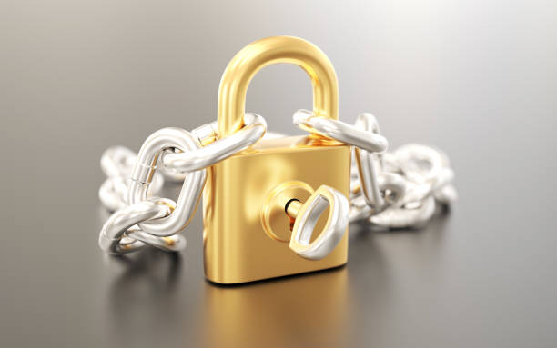 istock Golden padlock with silver chain and key 1309079086