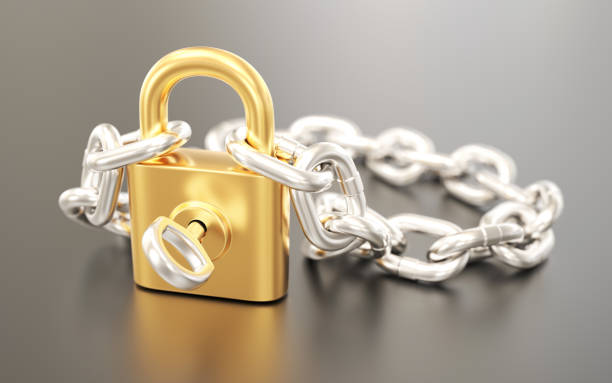 istock Golden padlock with silver chain and key 1309079176