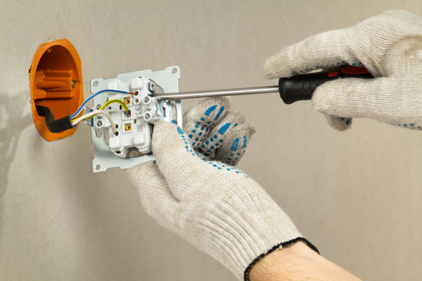 istock hands with gloves connects the electrical outlet to the mains 1309079332