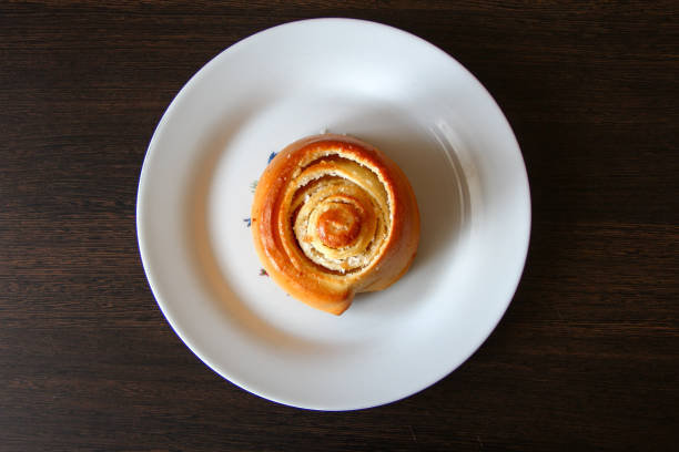 istock Twisted bun with coconut on a plate, top view 1309080563