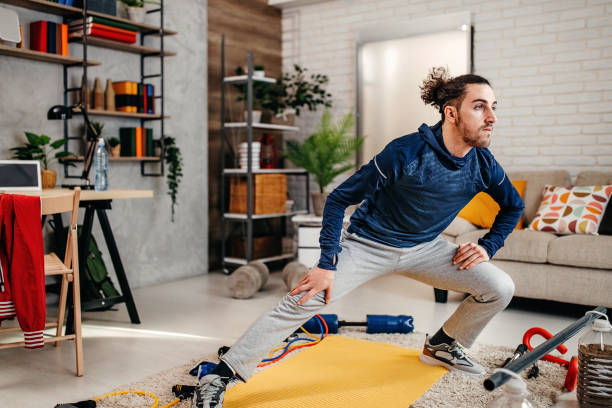 istock Young adult man doing sport training at home 1309080835