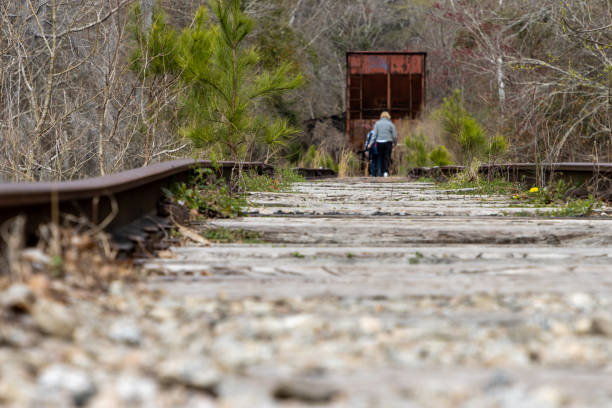 Person walking on abandoned train tracks