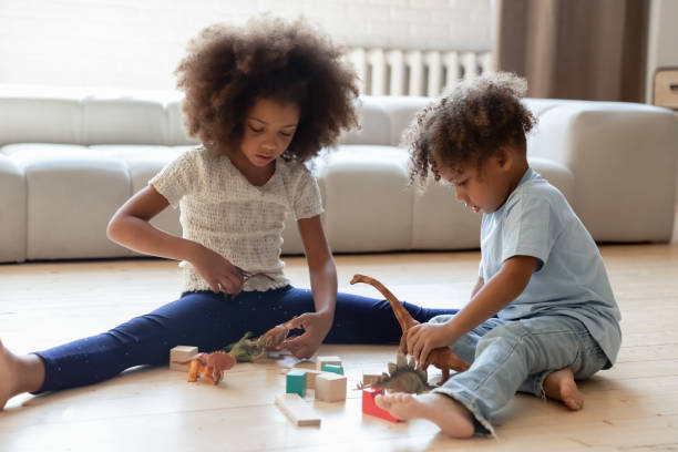istock Black african children enjoying interesting game on warm floor 1309082415