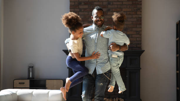 istock African male babysitter spending time at home with two kids 1309082455