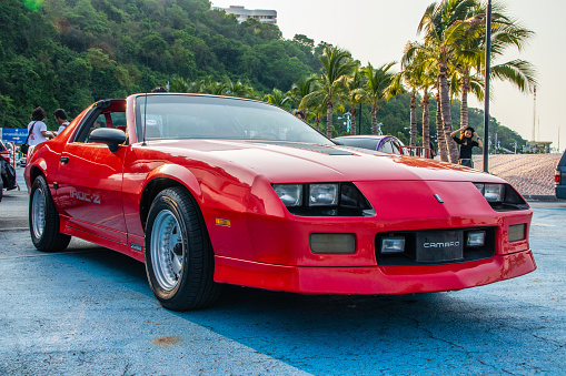 A red Chevrolet Camaro in Southeast Asia\nSeen at a show event in Thailand Asia\norganized by the Tourism Authority of Thailand at the port of Bali Hai in South Pattaya\nPattaya District Chonburi Thailand Asia\n03/20/2021