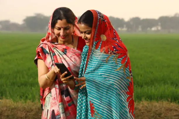 Photo of Rural women using phone in villlage