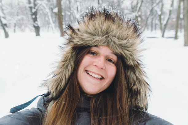 istock Young smiling woman taking selfie enjoying the first snow 1309084274