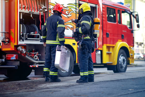 istock Firefighter, fireman. Emergency safety. Protection, rescue from danger. Firefighter in protective helmet. man in equipment, uniform at work. 1309085410