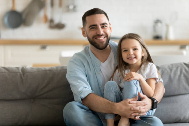 istock Portrait smiling father and little daughter hugging, looking at camera 1309085630