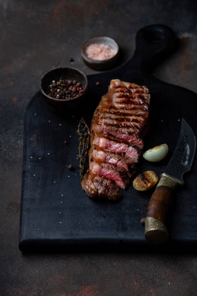 istock Sliced grilled beef barbecue Striploin steak with thyme 1309088075