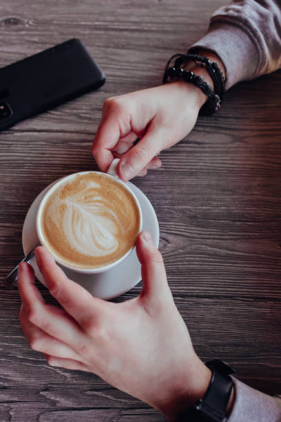 istock men's hands hold a cup of coffee. 1309088180