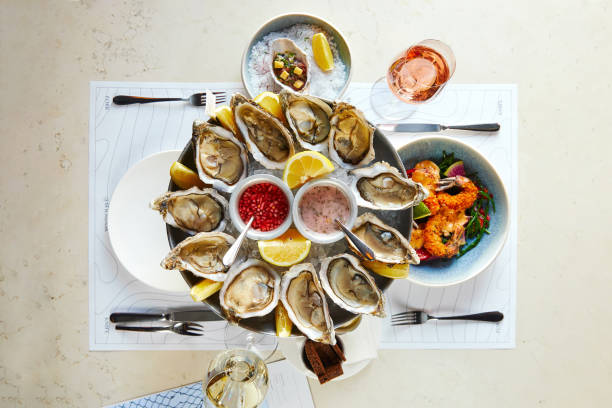 istock Seafood platter with opened oysters with sauce and shrimp 1309088591