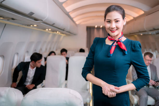 istock Beautiful flight attendant in an airplane smiling 1309089809