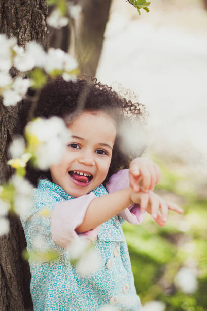 Funny little girl in springtime garden
