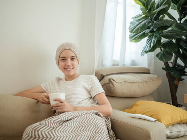istock Happy woman with cancer drinking tea. 1309091753