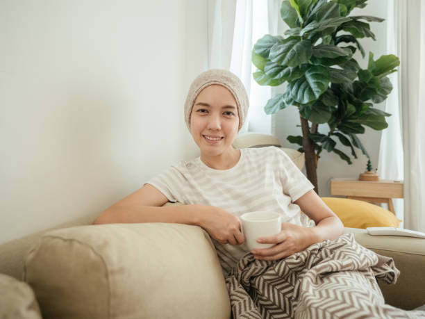 istock Happy woman with cancer drinking tea. 1309092275