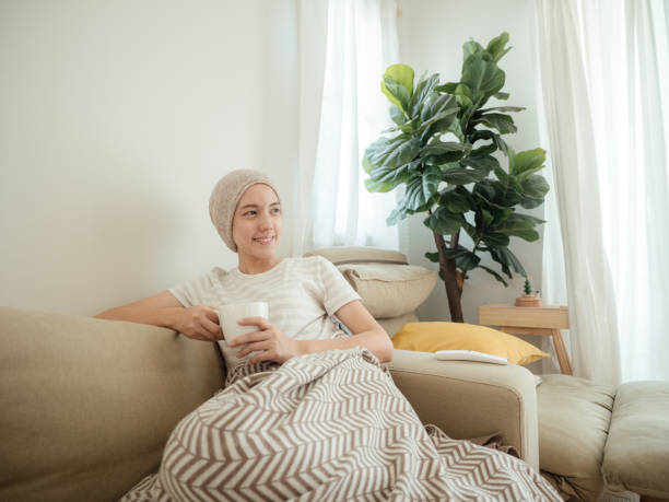 istock Happy woman with cancer drinking tea. 1309092324