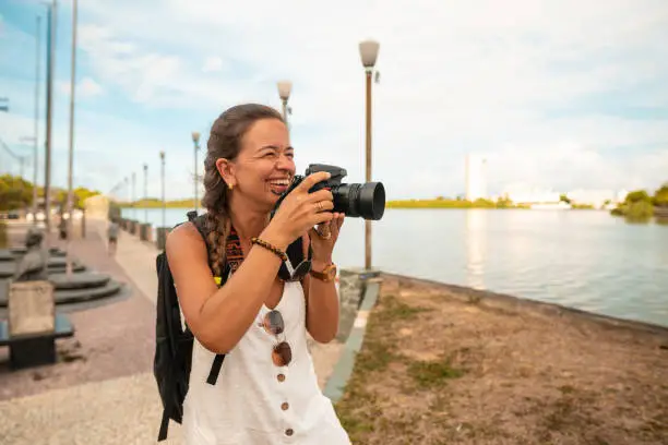 Photo of Woman photographs Capibaribe River in Recife, Pernambuco