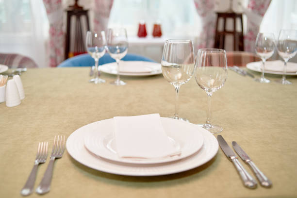 istock Table setting with empty white plate, napkin and cutlery on table, copy space. Menu mockup, place setting at wedding reception. Table served for wedding banquet in restauran 1309094747