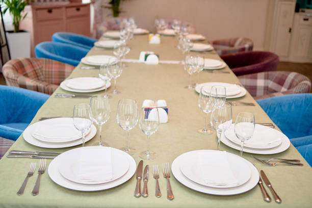 istock Table set with white plates, napkins , cutlery and wineglasses on table, copy space. Place setting at wedding reception. Table served for banquet in restaurant 1309094763