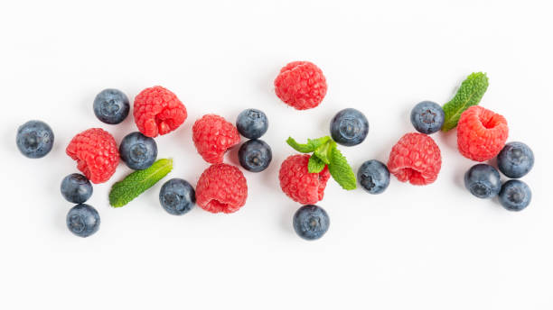 istock Fresh blueberries and raspberries plate on white background top view. 1309094947