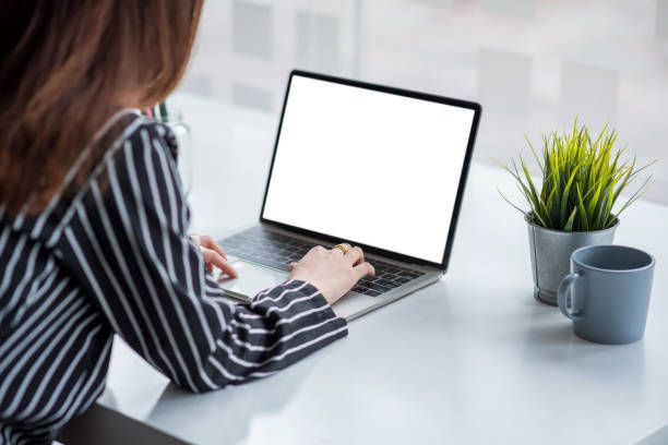 istock Close up. Hand businesswoman using laptop on white screen on table. Mock up. 1309095036