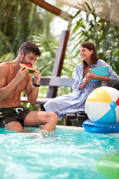 istock Man with woman on swimming pool 1309095099